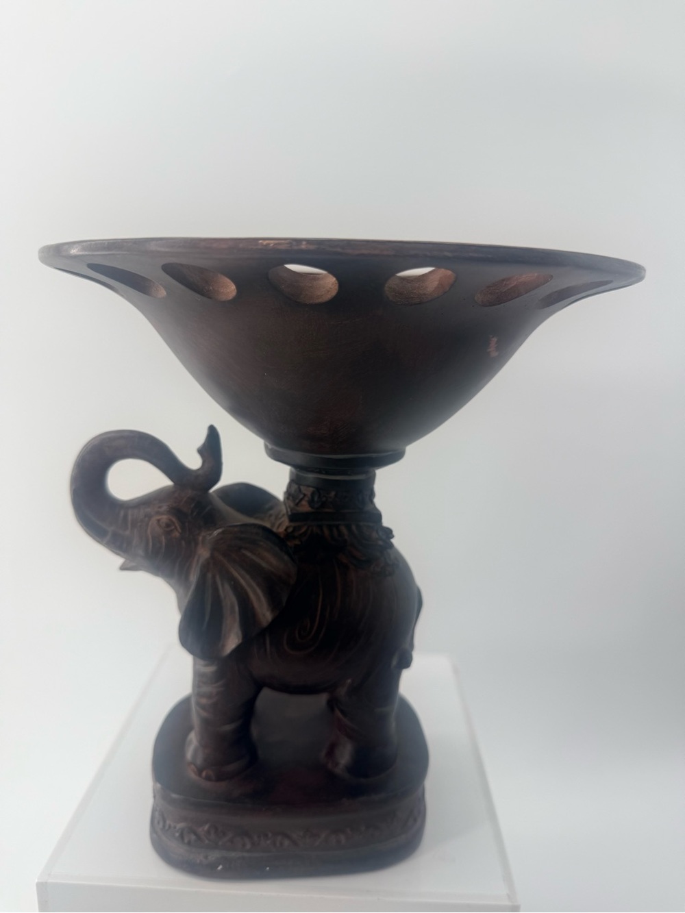 Decorative elephant pedestal centerpiece. Showcasing an elephant figurine.